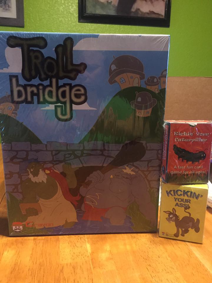 box shots of Troll Bridge, Kickin' your Caterpillar and Kickin' your Ass. 
